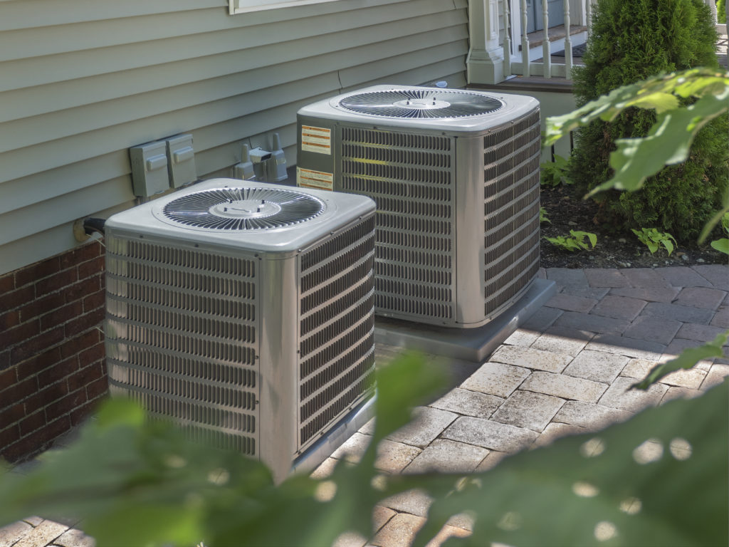 HVAC residential units on concrete slab outside a West Chester home.
